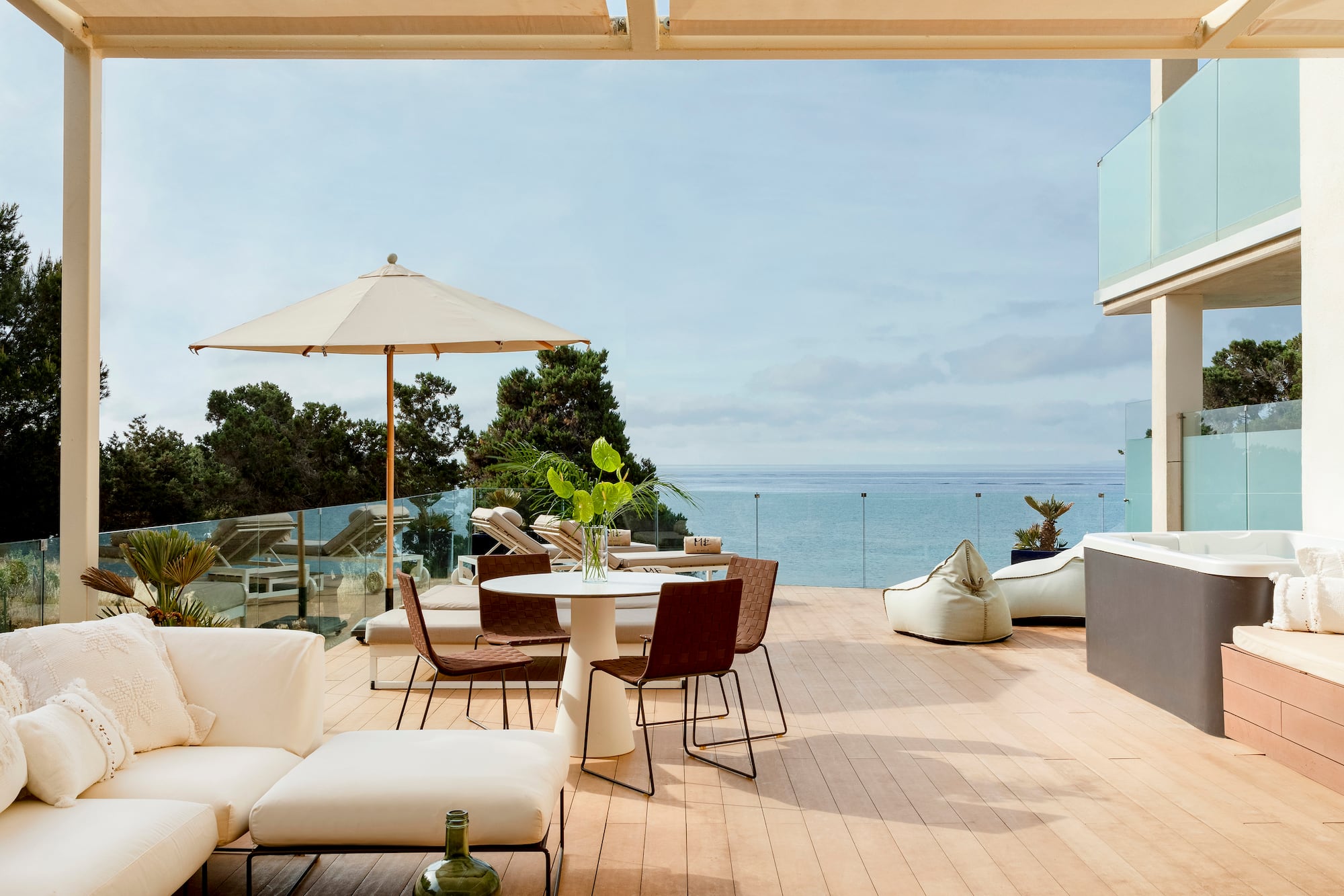 a patio with a table and chairs and umbrellas