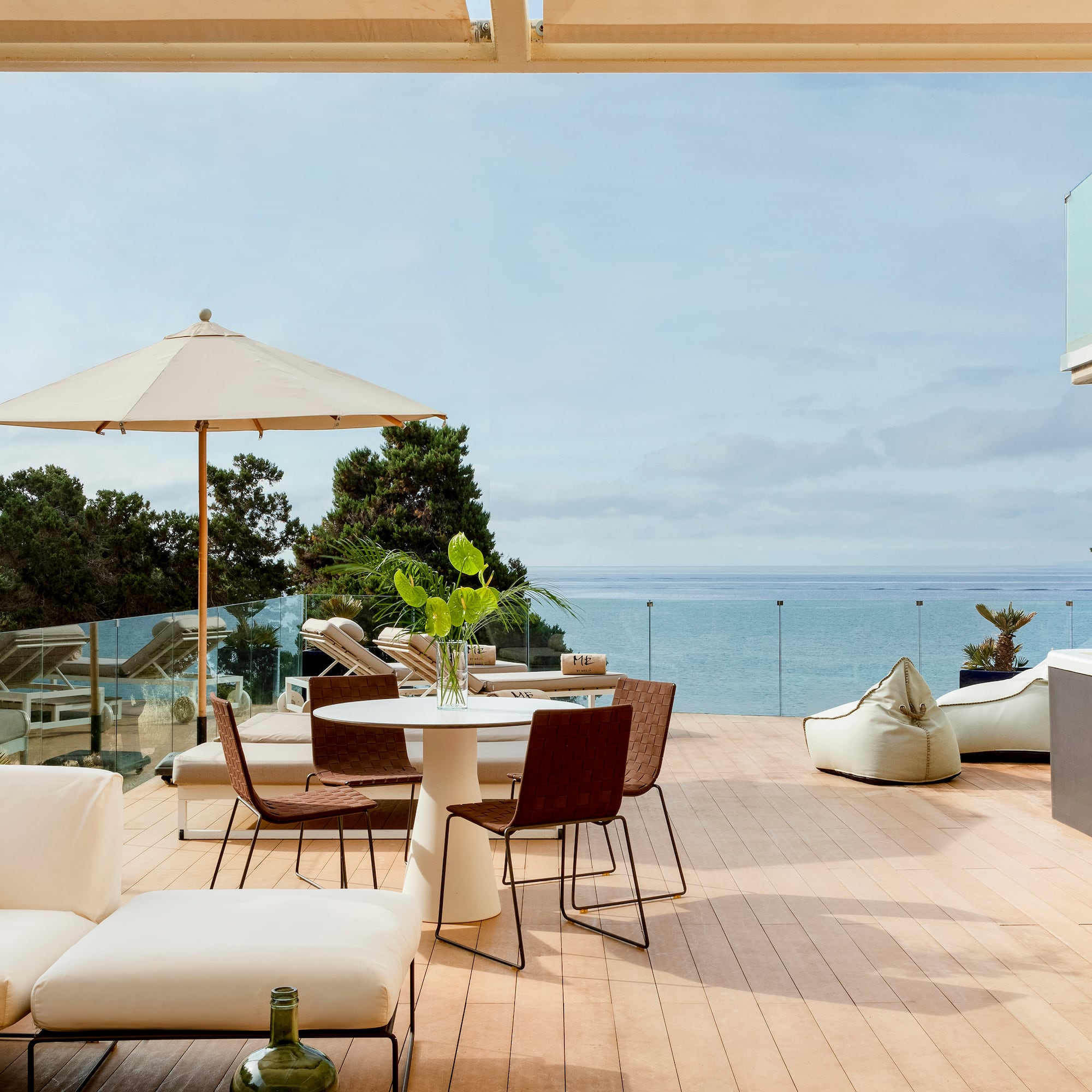 a patio with a table and chairs and umbrellas