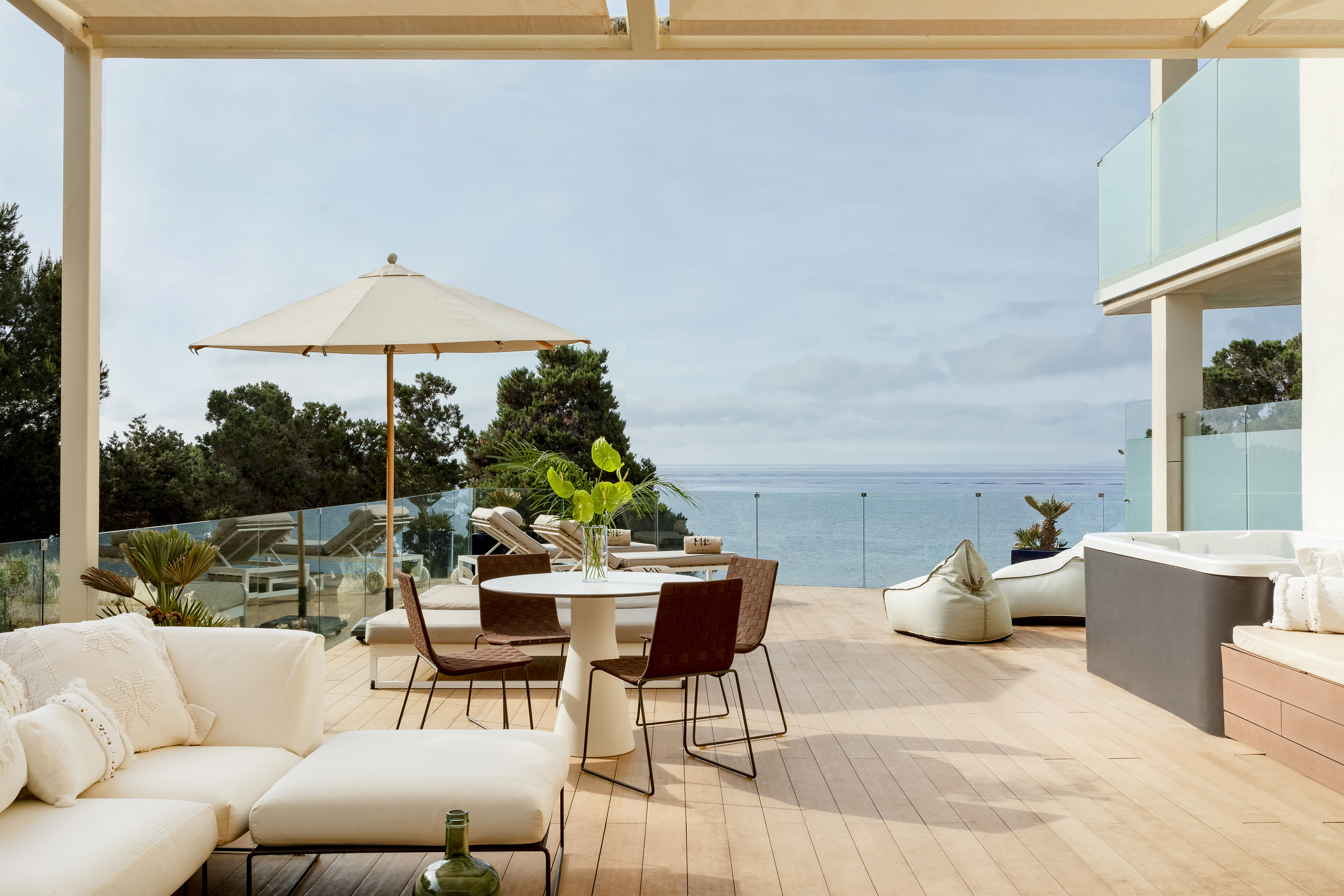 a patio with a table and chairs and umbrellas