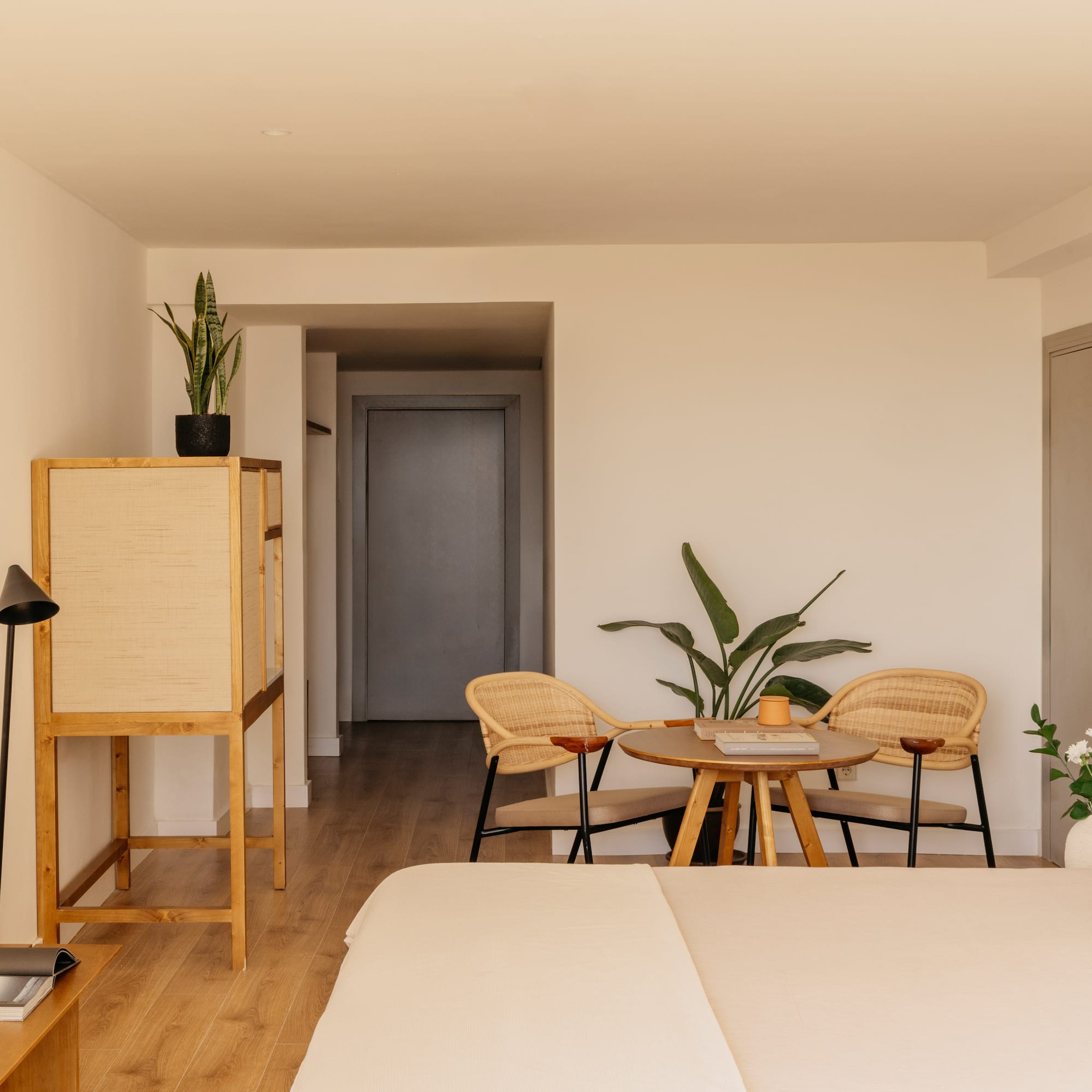 a room with a bed and chairs and a table