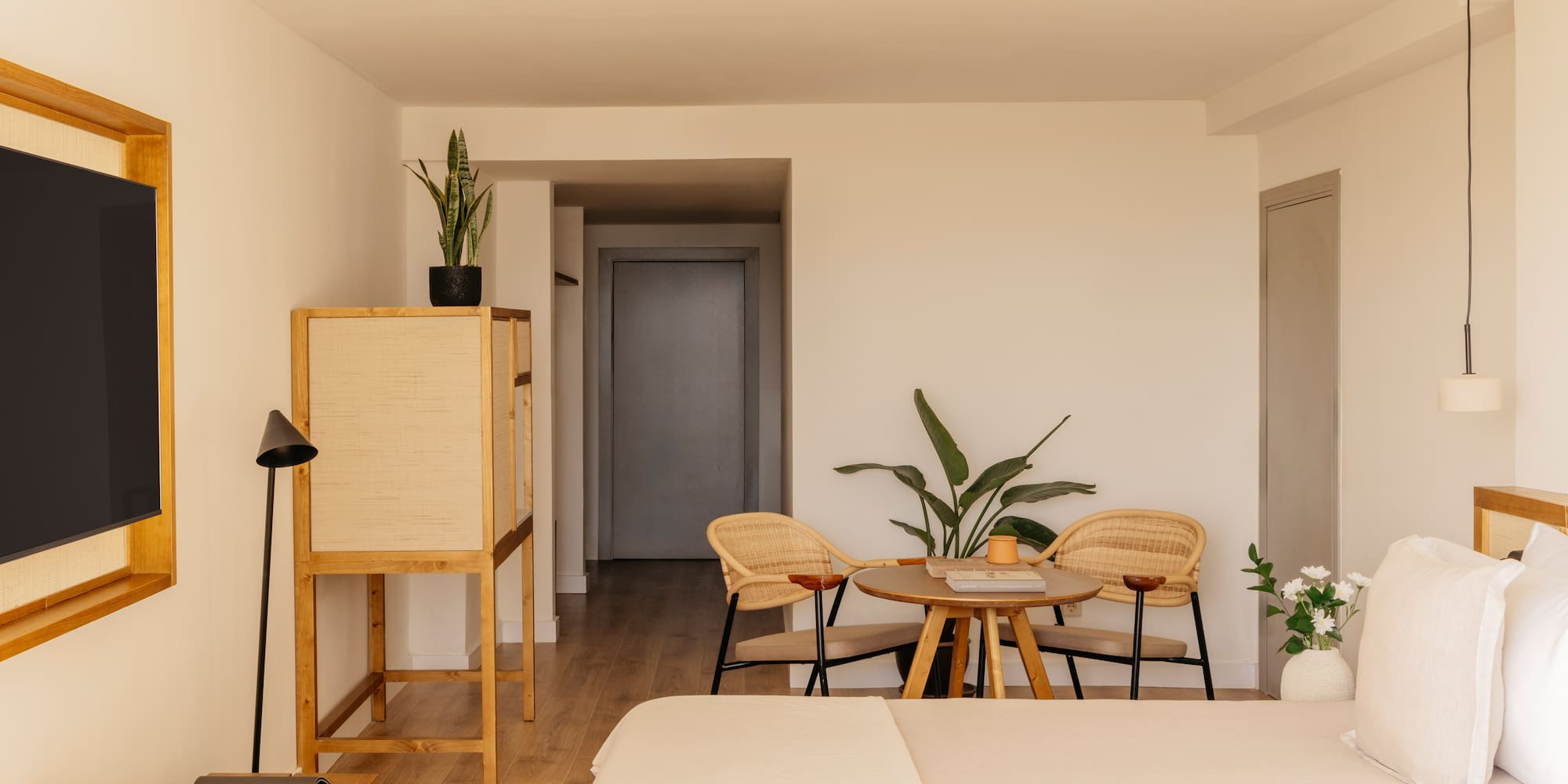 a room with a bed and chairs and a table