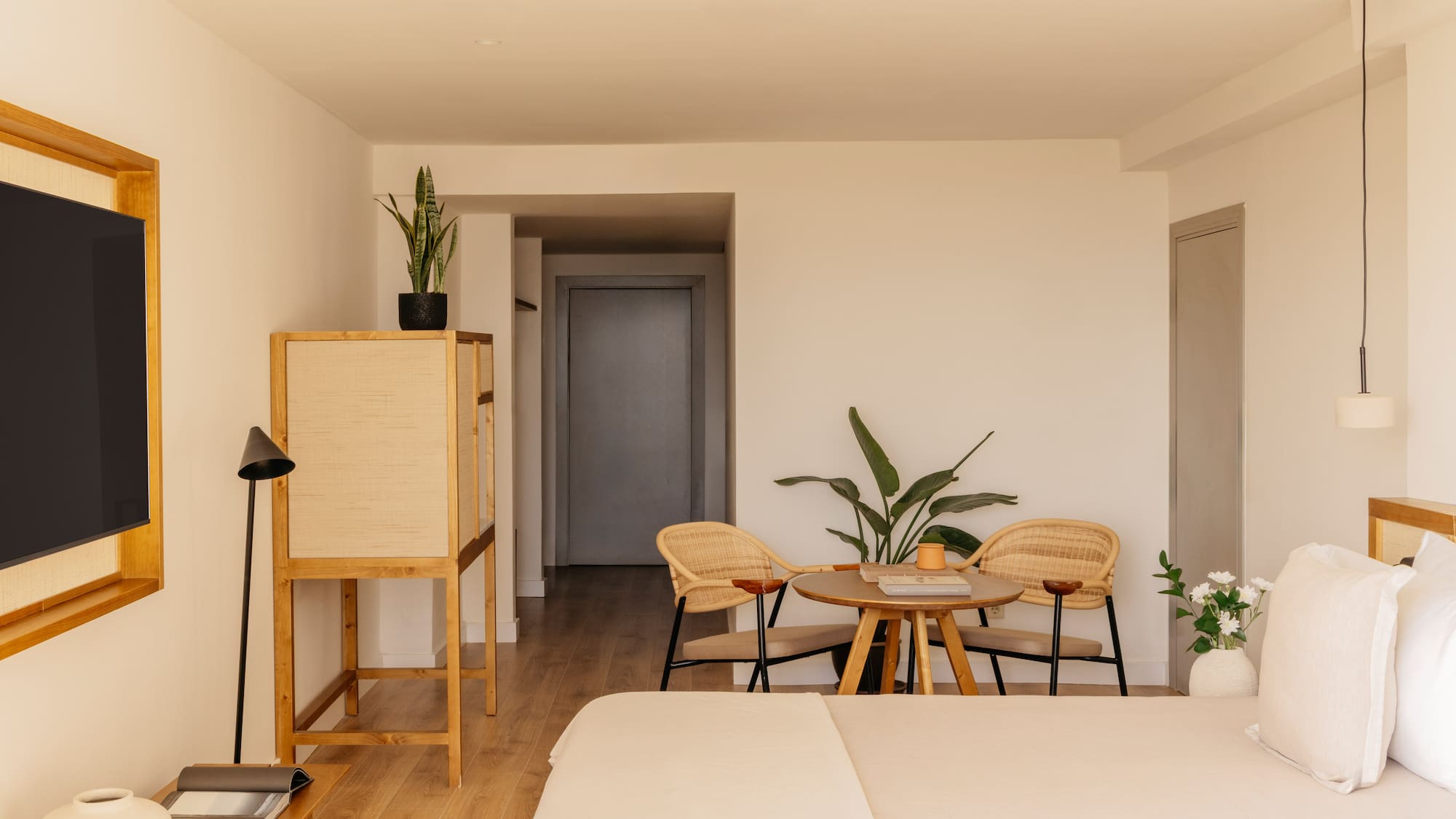 a room with a bed and chairs and a table