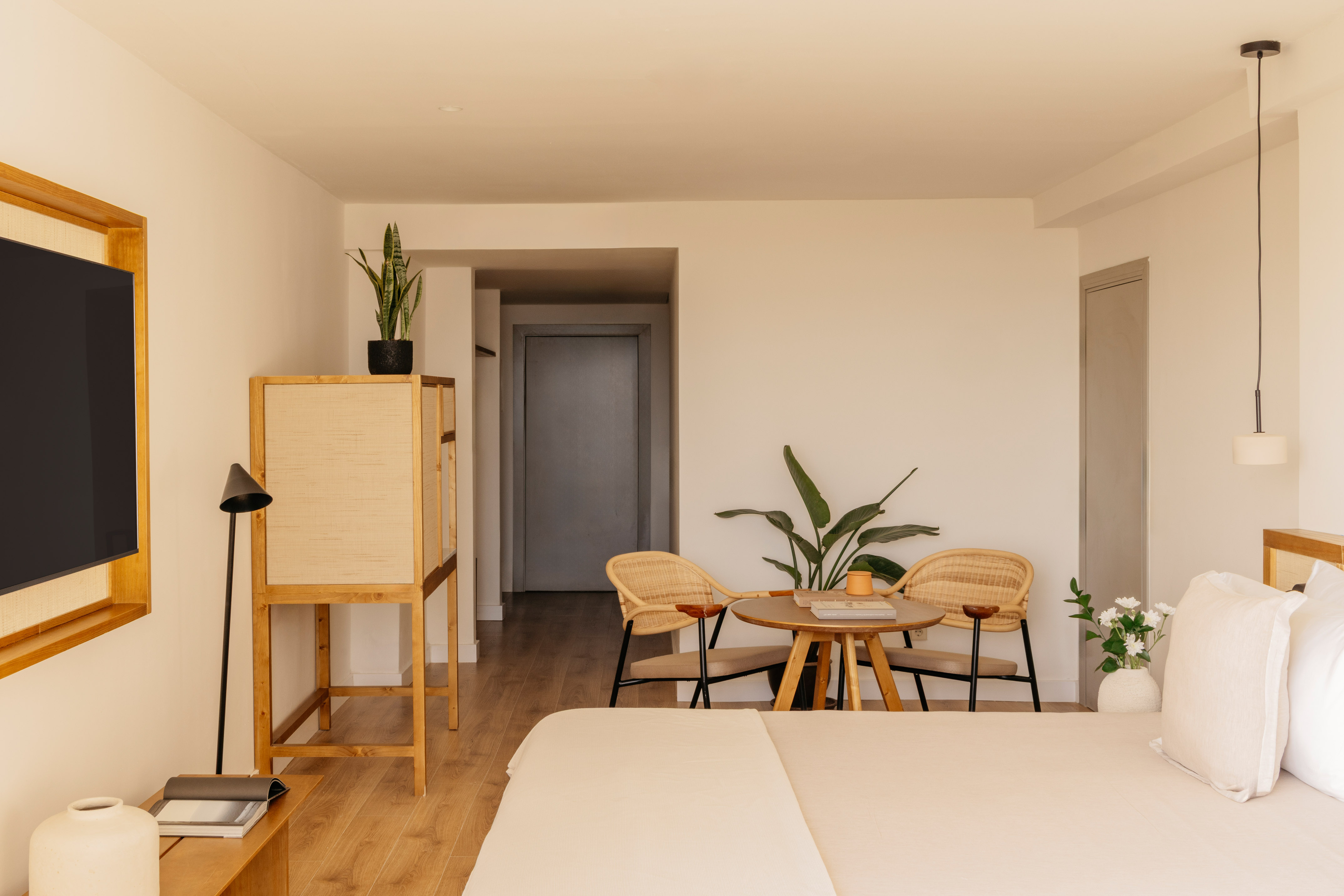 a room with a bed and chairs and a table