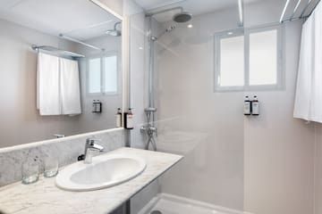 a bathroom with a shower and sink