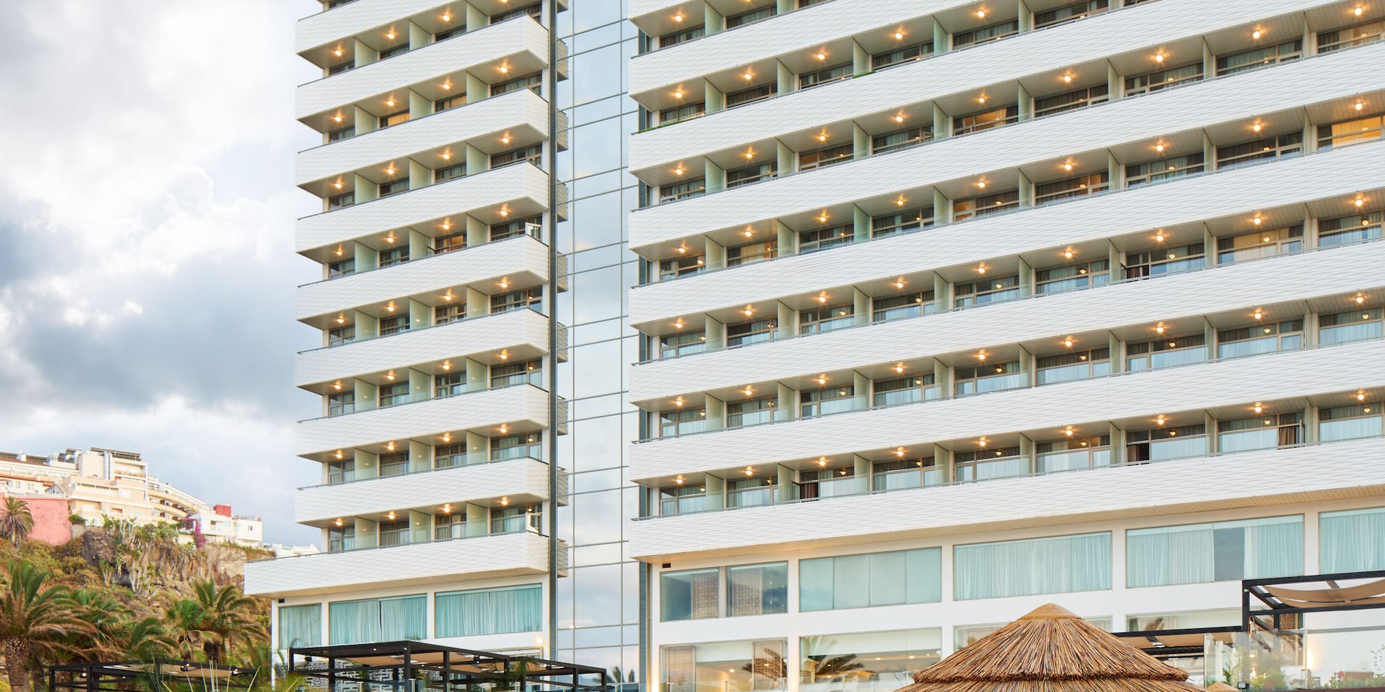 a large building with many chairs and umbrellas