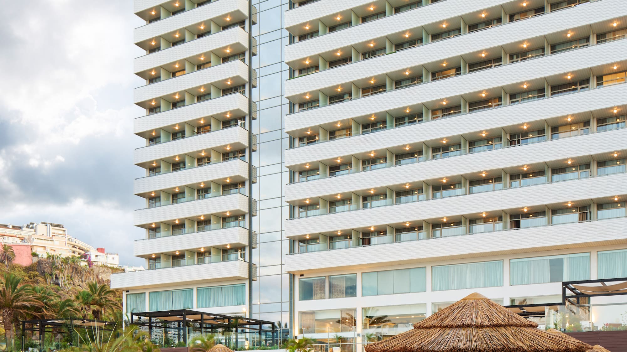 a large building with many chairs and umbrellas
