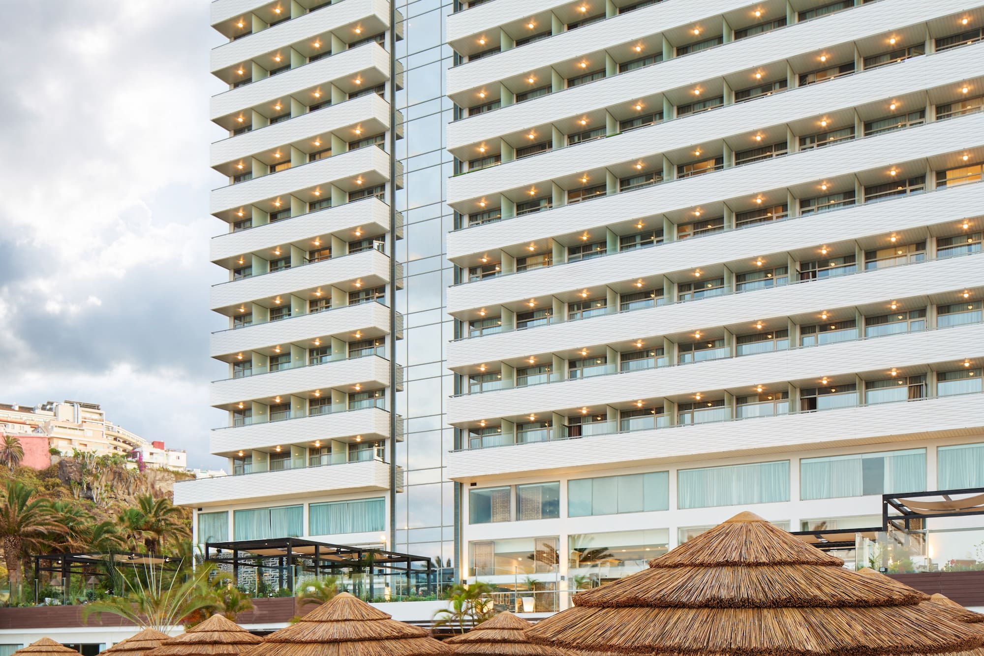 a large building with many chairs and umbrellas