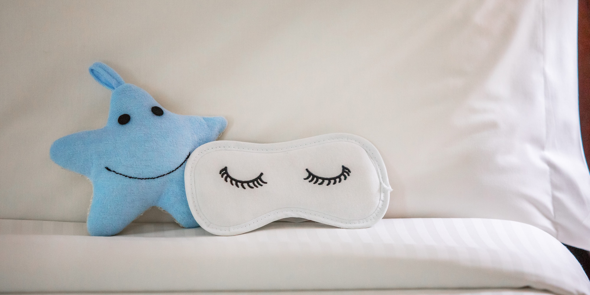 a blue star and eye mask on a white surface