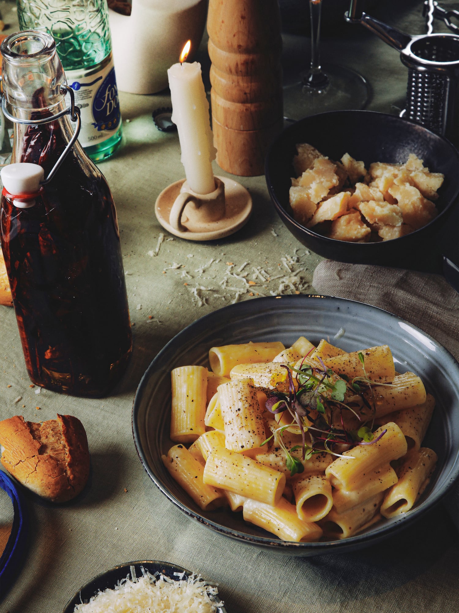 a plate of pasta and a bottle of sauce
