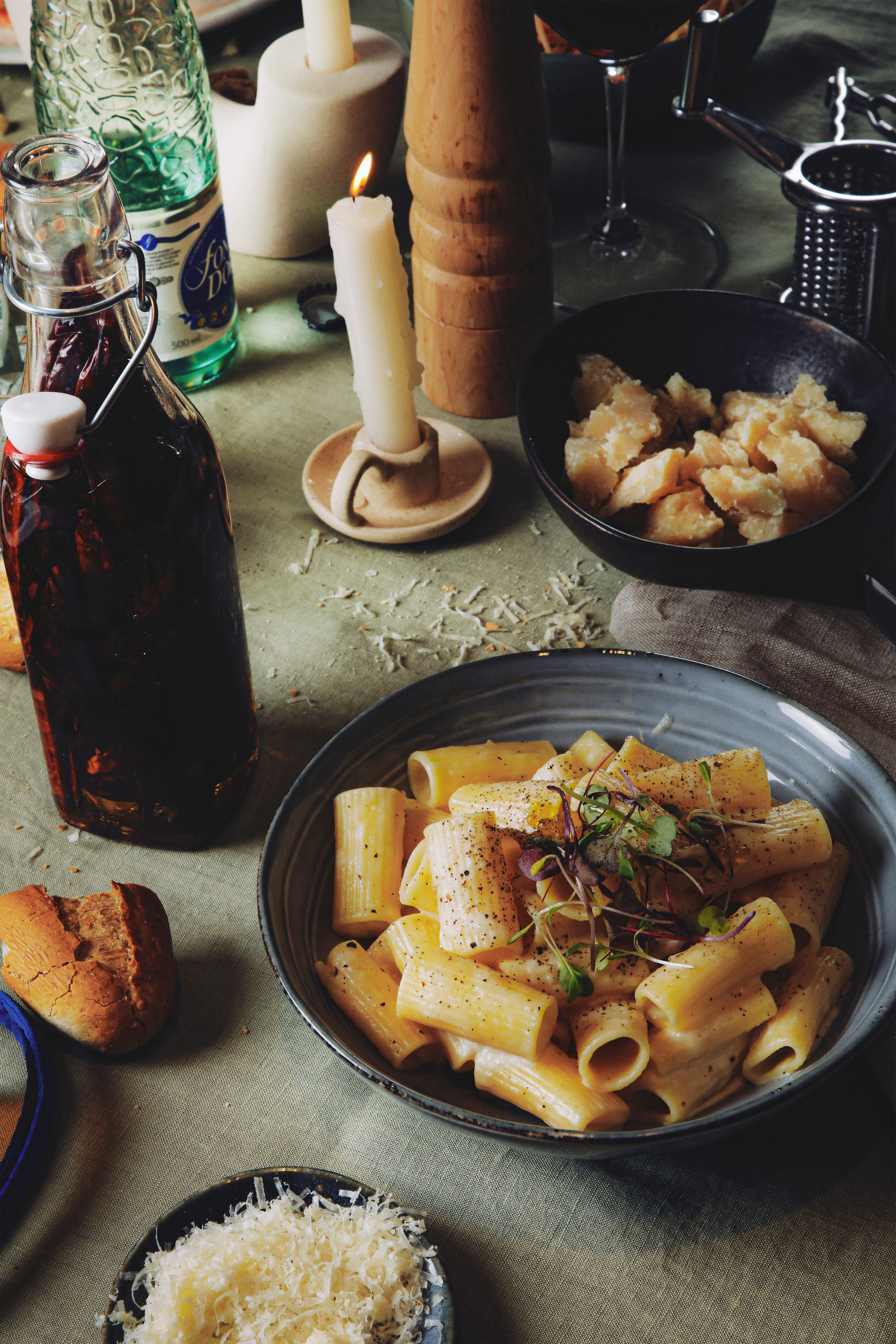 a plate of pasta and a bottle of sauce