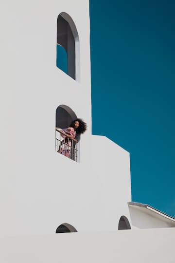a woman standing on a balcony