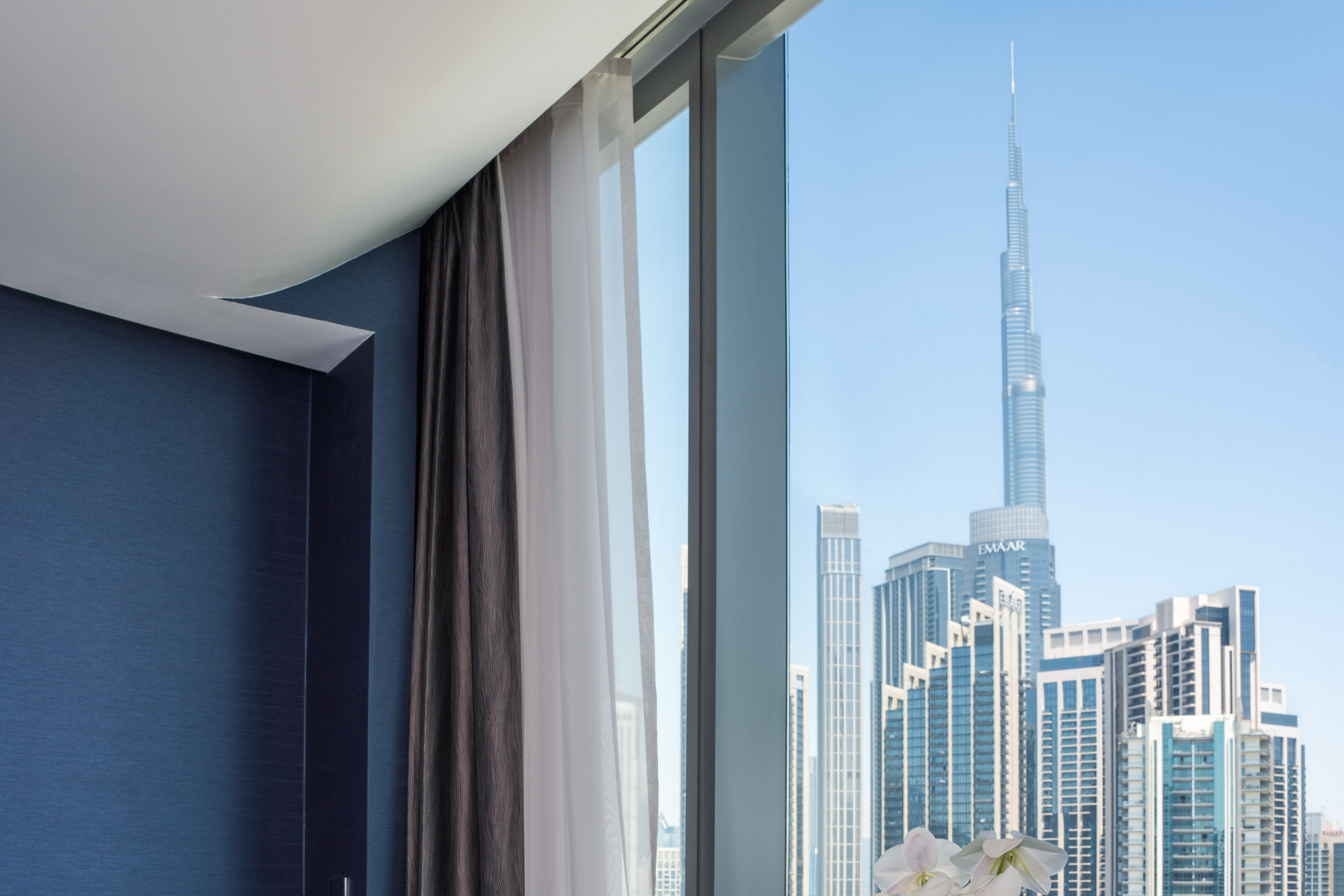 Dubai hotel room with city skyline view, featuring iconic Burj Khalifa.