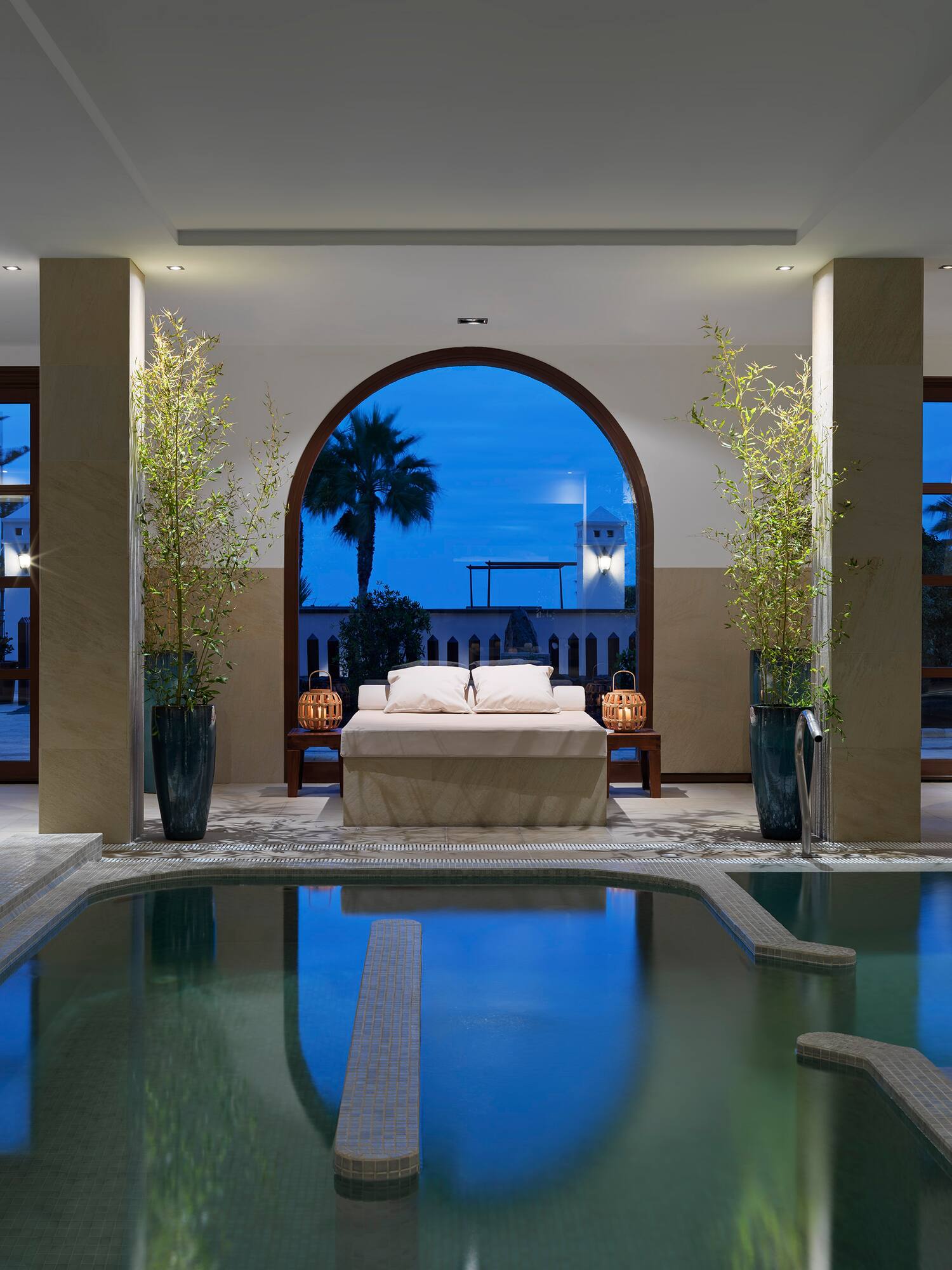 a indoor pool with a bed and a couch