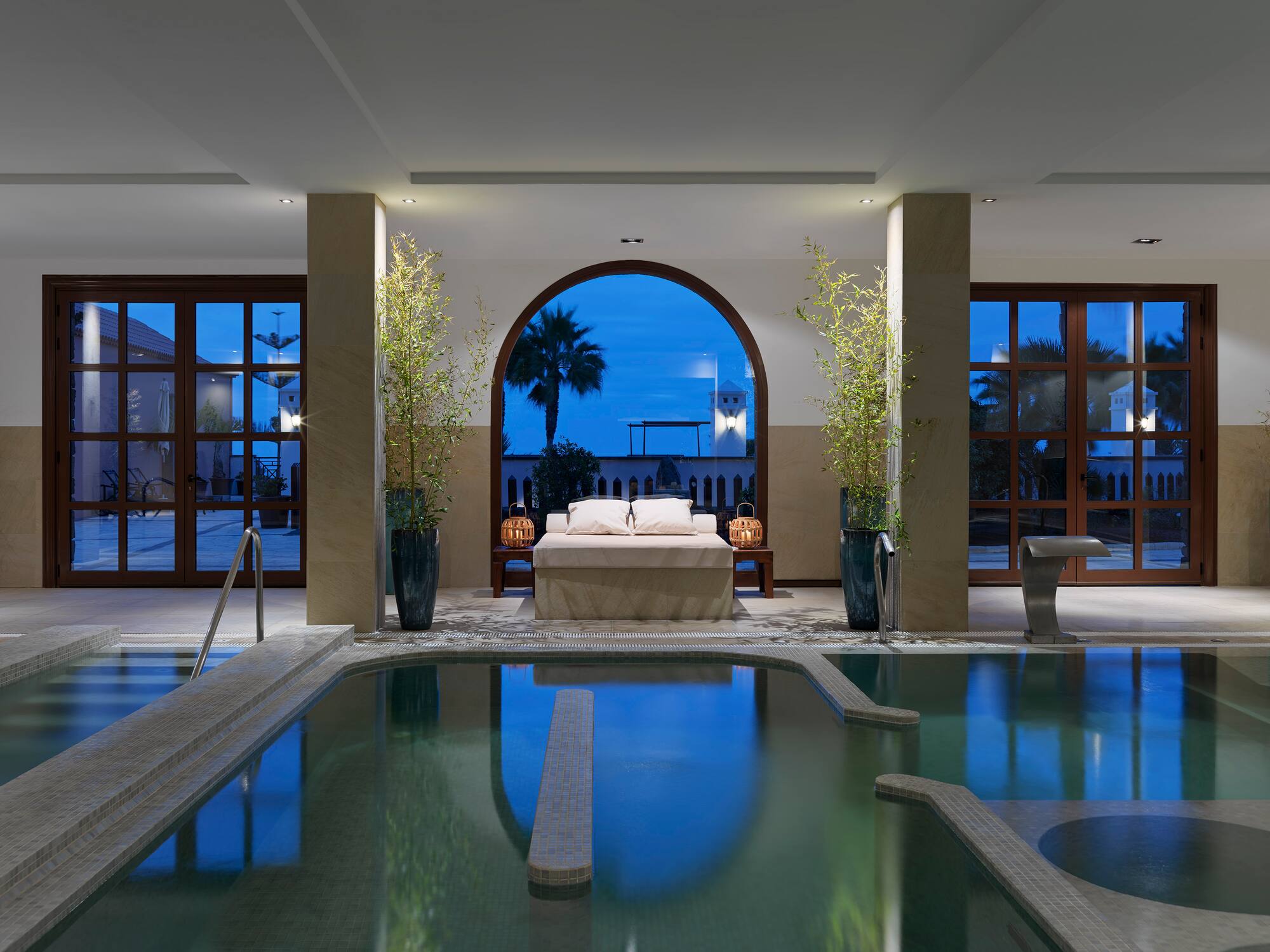 a indoor pool with a bed and a couch