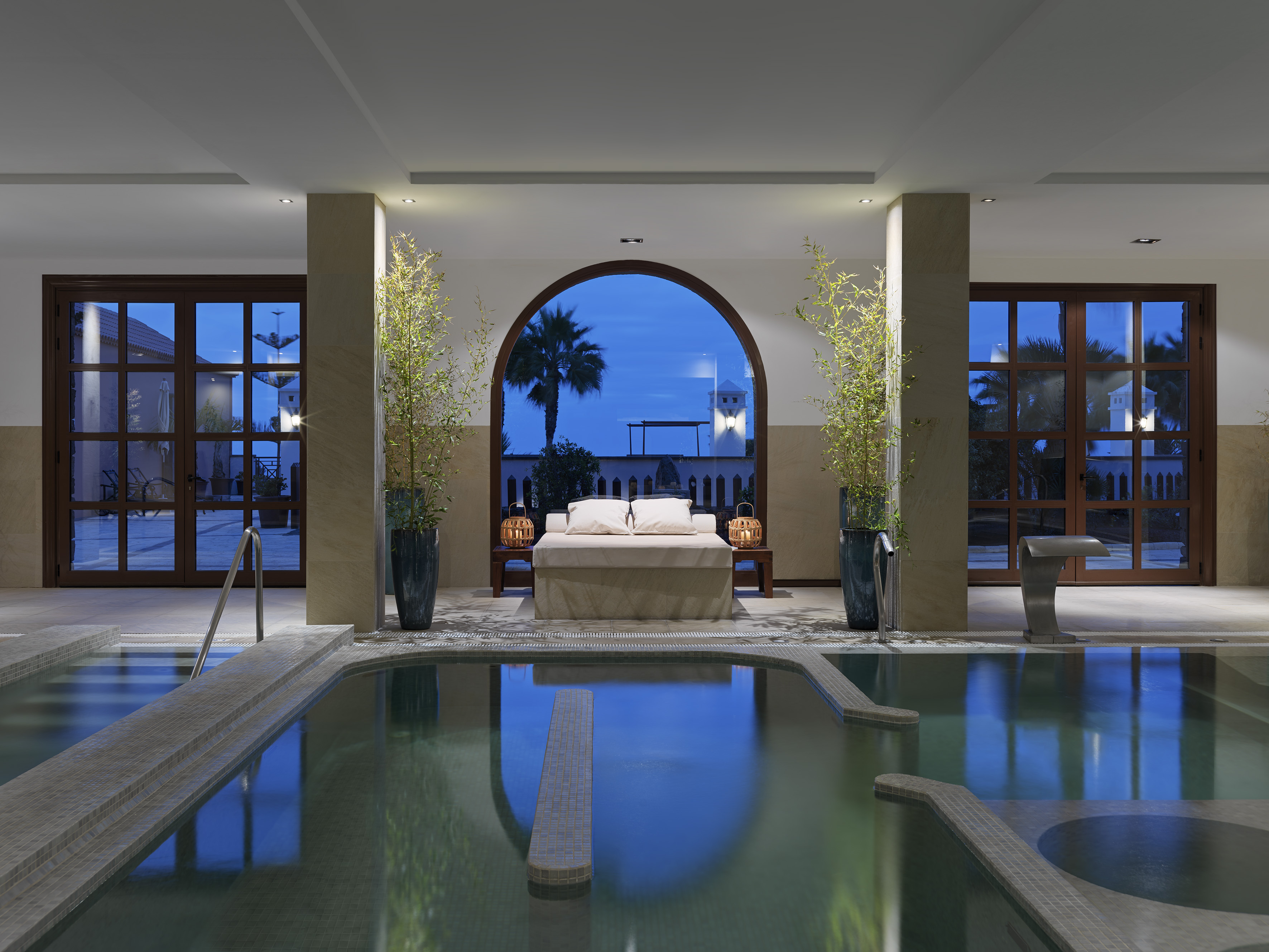 a indoor pool with a bed and a couch
