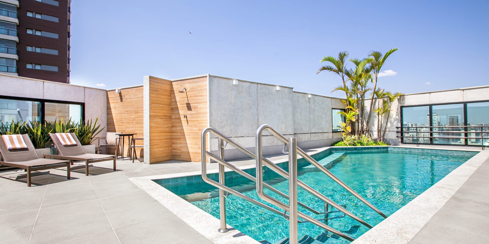 a swimming pool with a metal railing