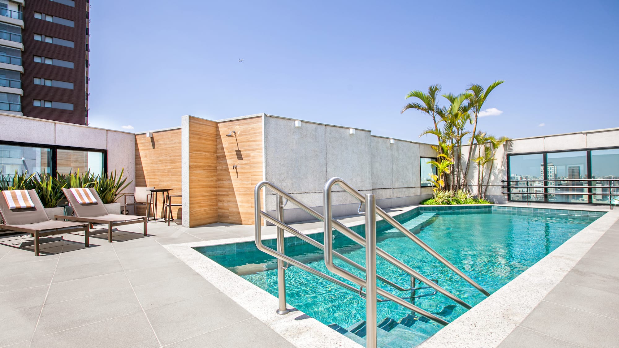 a swimming pool with a metal railing