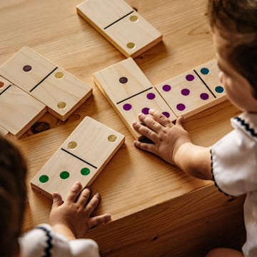a child playing with dominoes