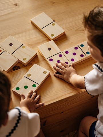a child playing with dominoes