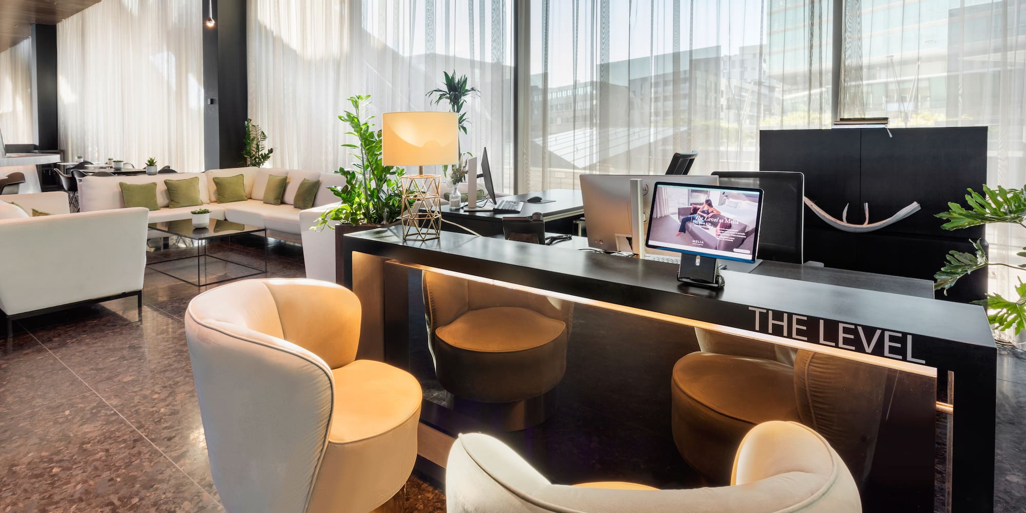 a room with a desk and chairs