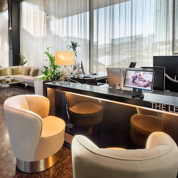 a room with a desk and chairs