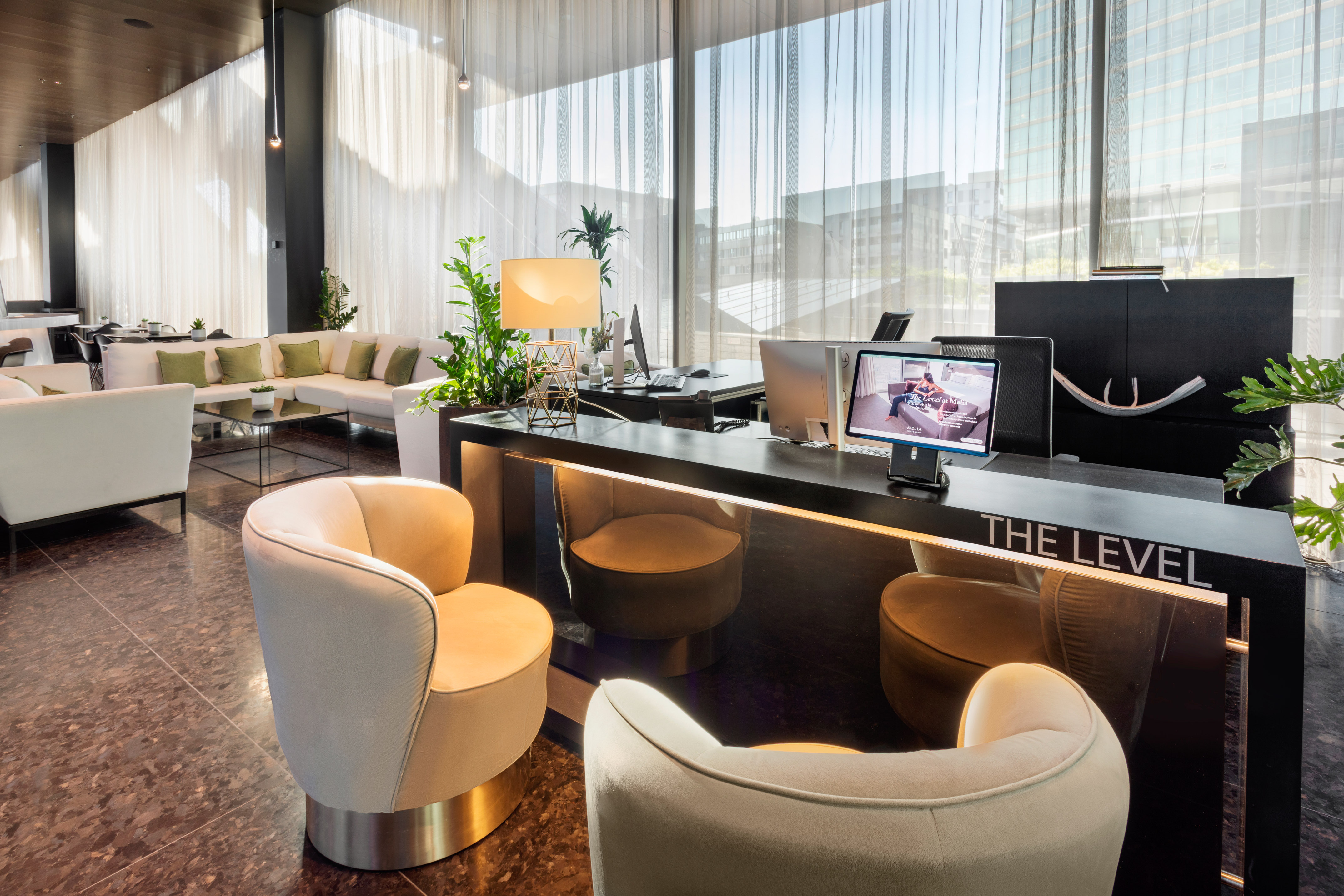 THE LEVEL hotel reception desk and contemporary lobby lounge with plush seating.