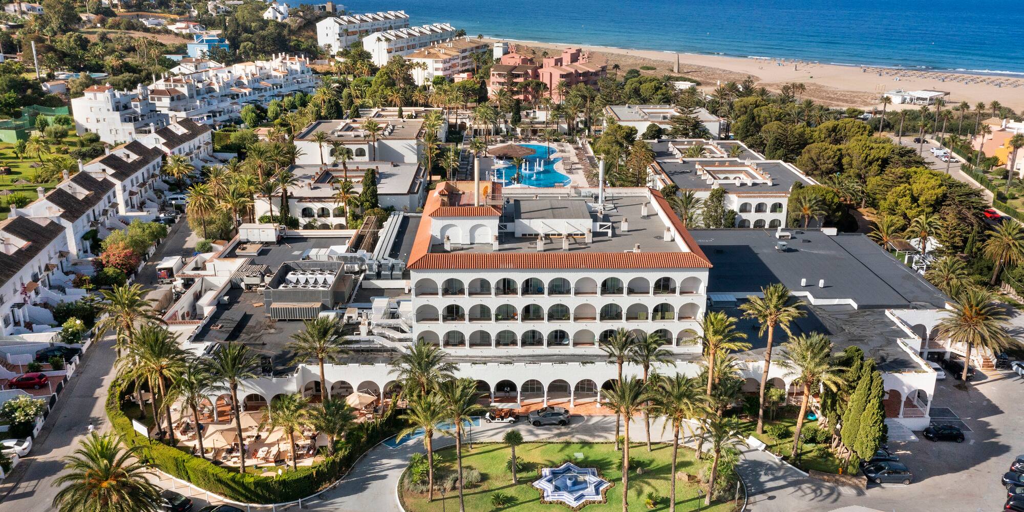 a aerial view of a resort with a pool and trees