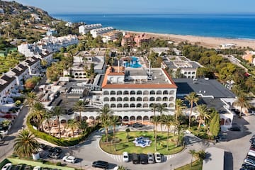 a aerial view of a resort with a pool and trees