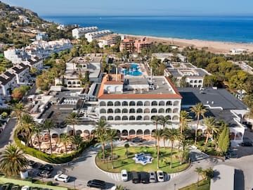 a aerial view of a resort with a pool and trees