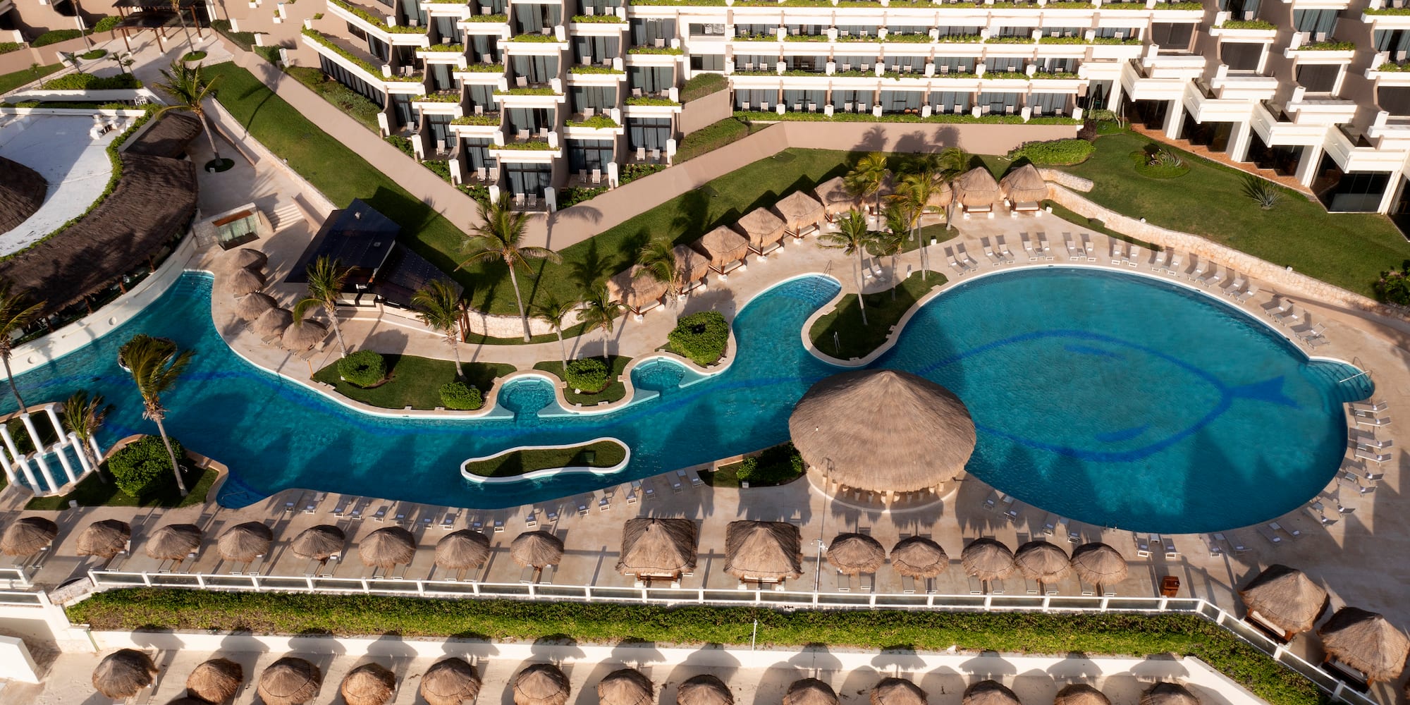a pool and a building with a thatched roof