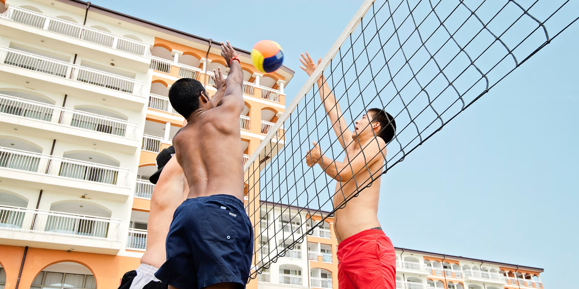 a group of men playing volleyball