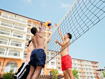a group of men playing volleyball