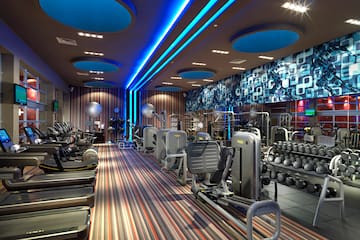 a room with exercise equipment and a blue and white wall