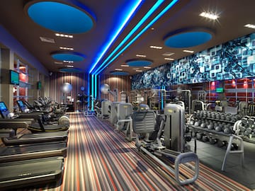 a room with exercise equipment and a blue and white wall