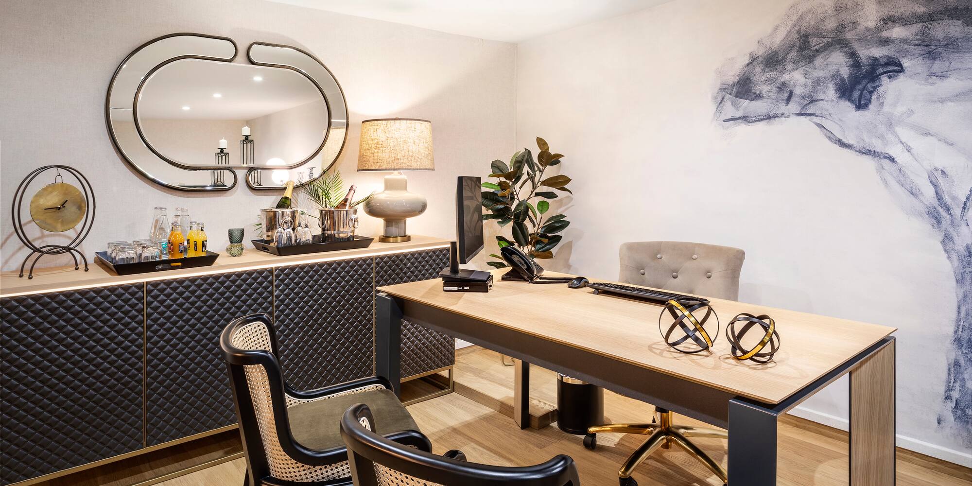 a room with a desk and chairs