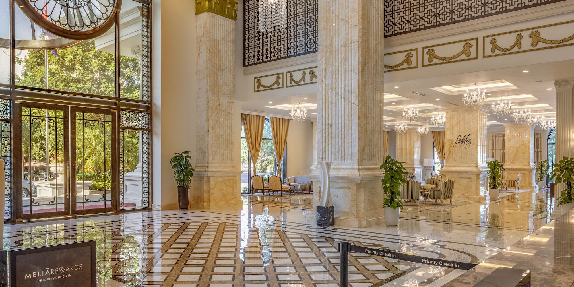 a large hall with marble flooring and chandeliers