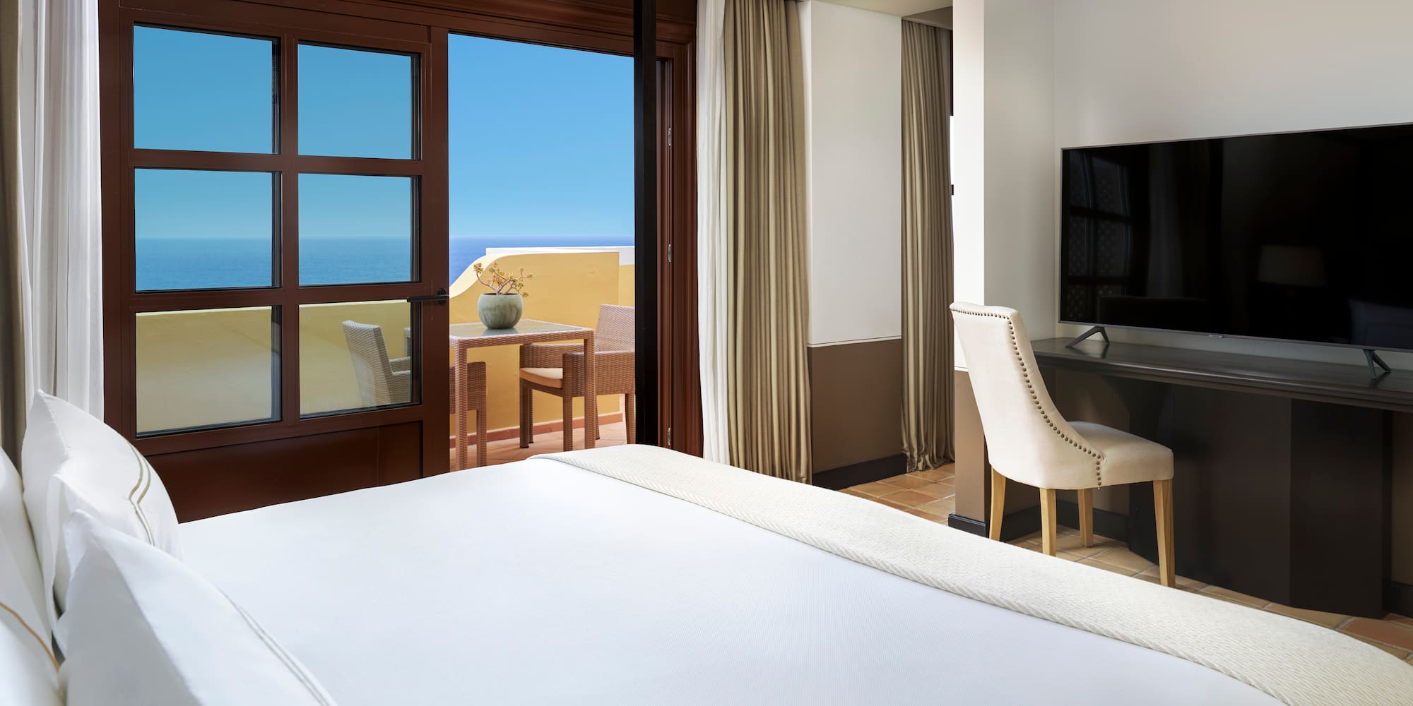 a room with a bed and a television