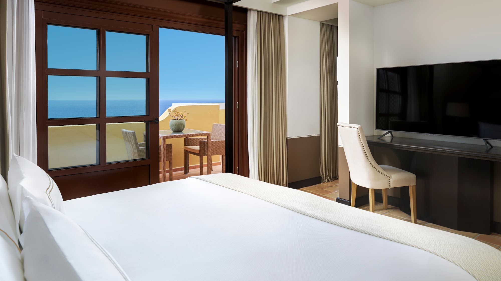 a room with a bed and a television