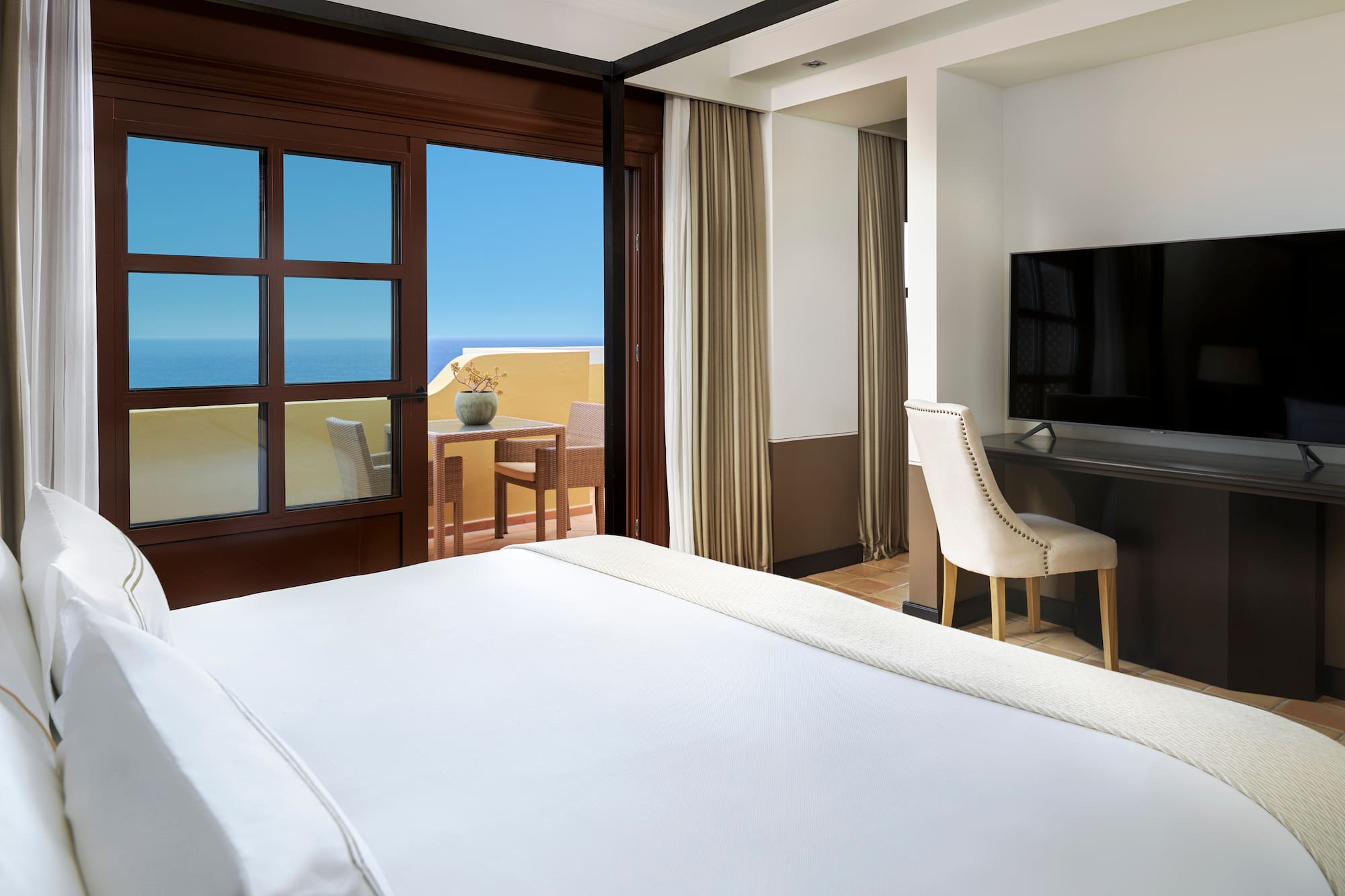 a room with a bed and a television