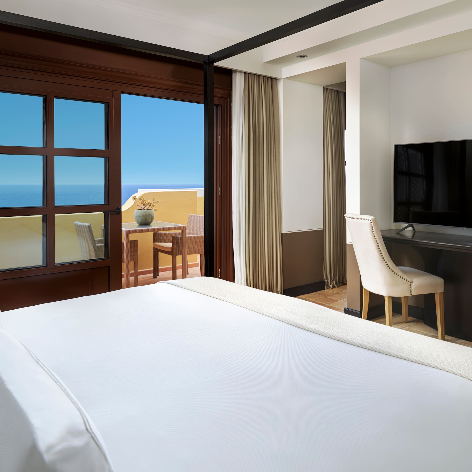 a room with a bed and a television