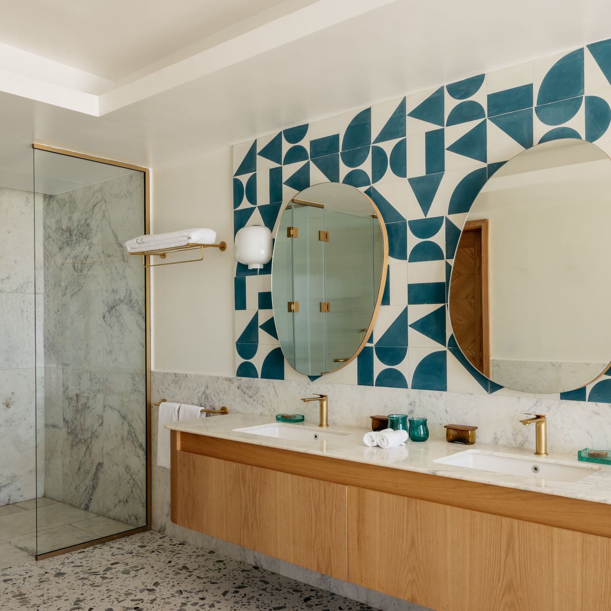 a bathroom with a shower and double sinks