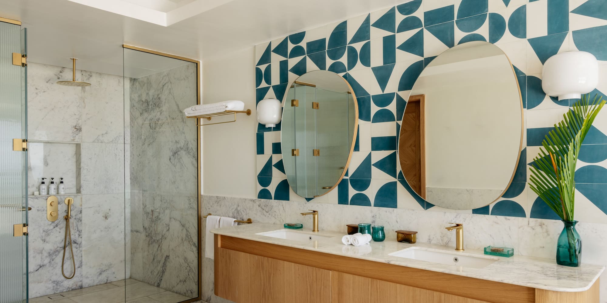 a bathroom with a shower and double sinks