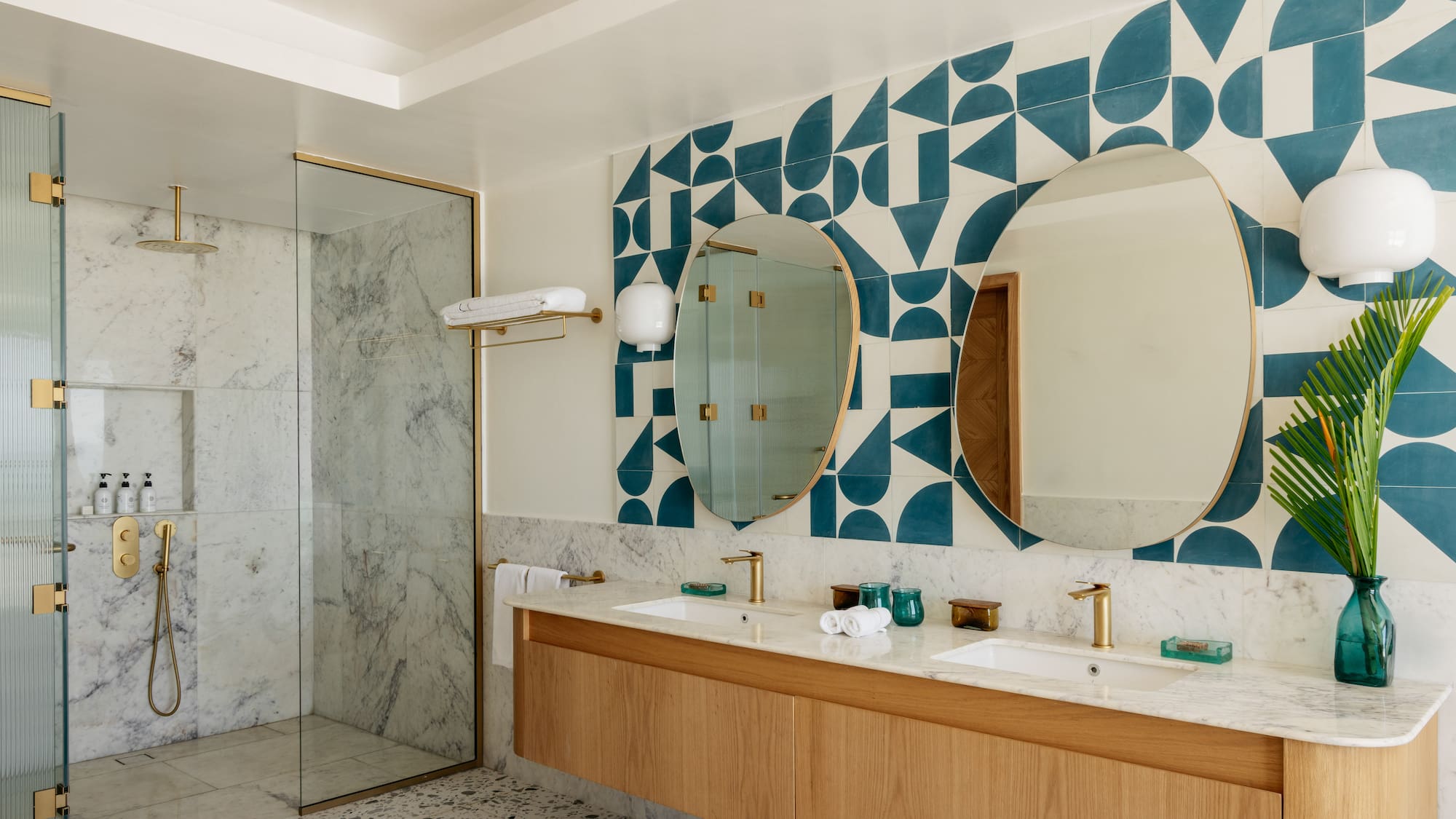a bathroom with a shower and double sinks