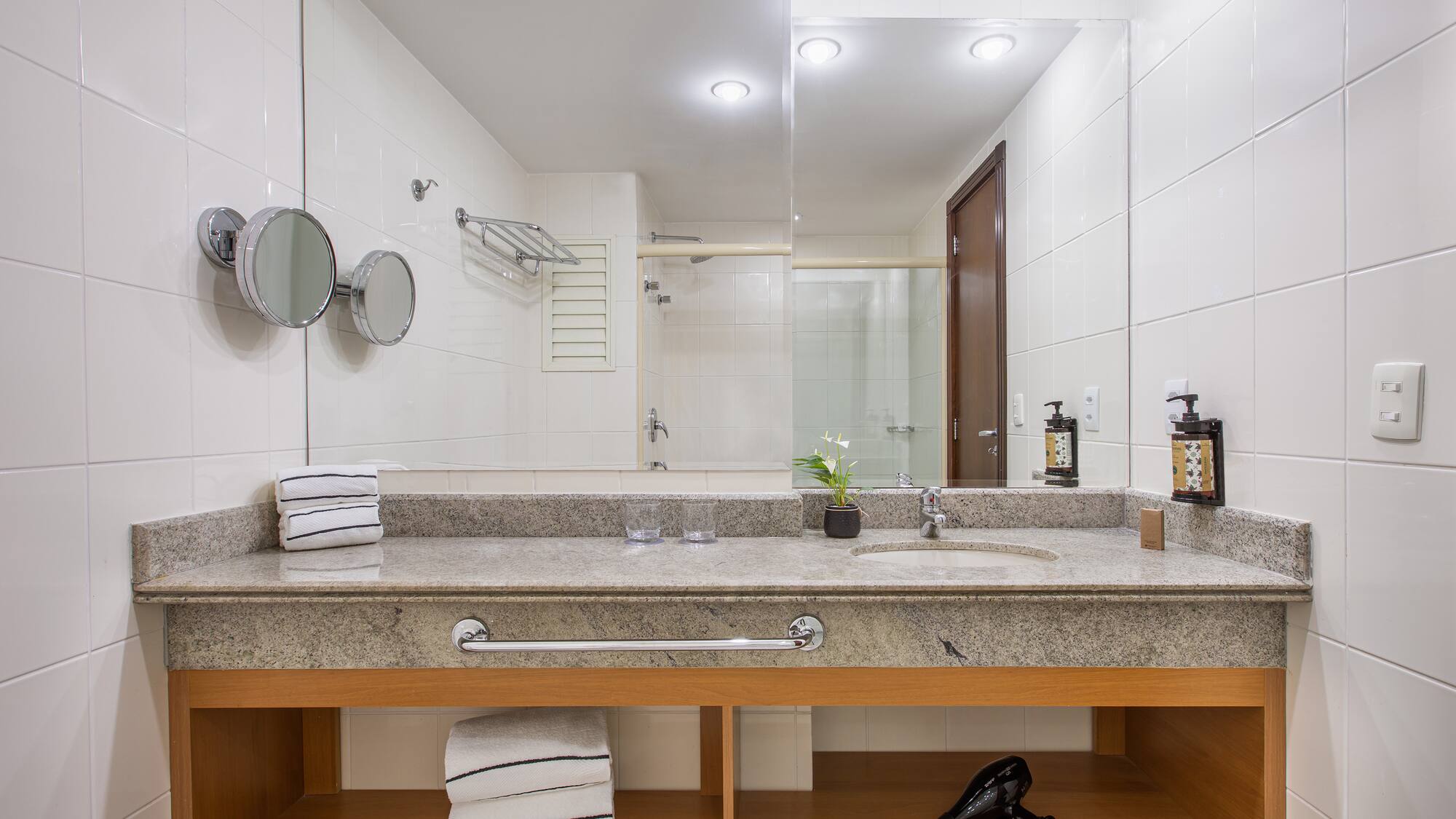 a bathroom with a sink and a blow dryer