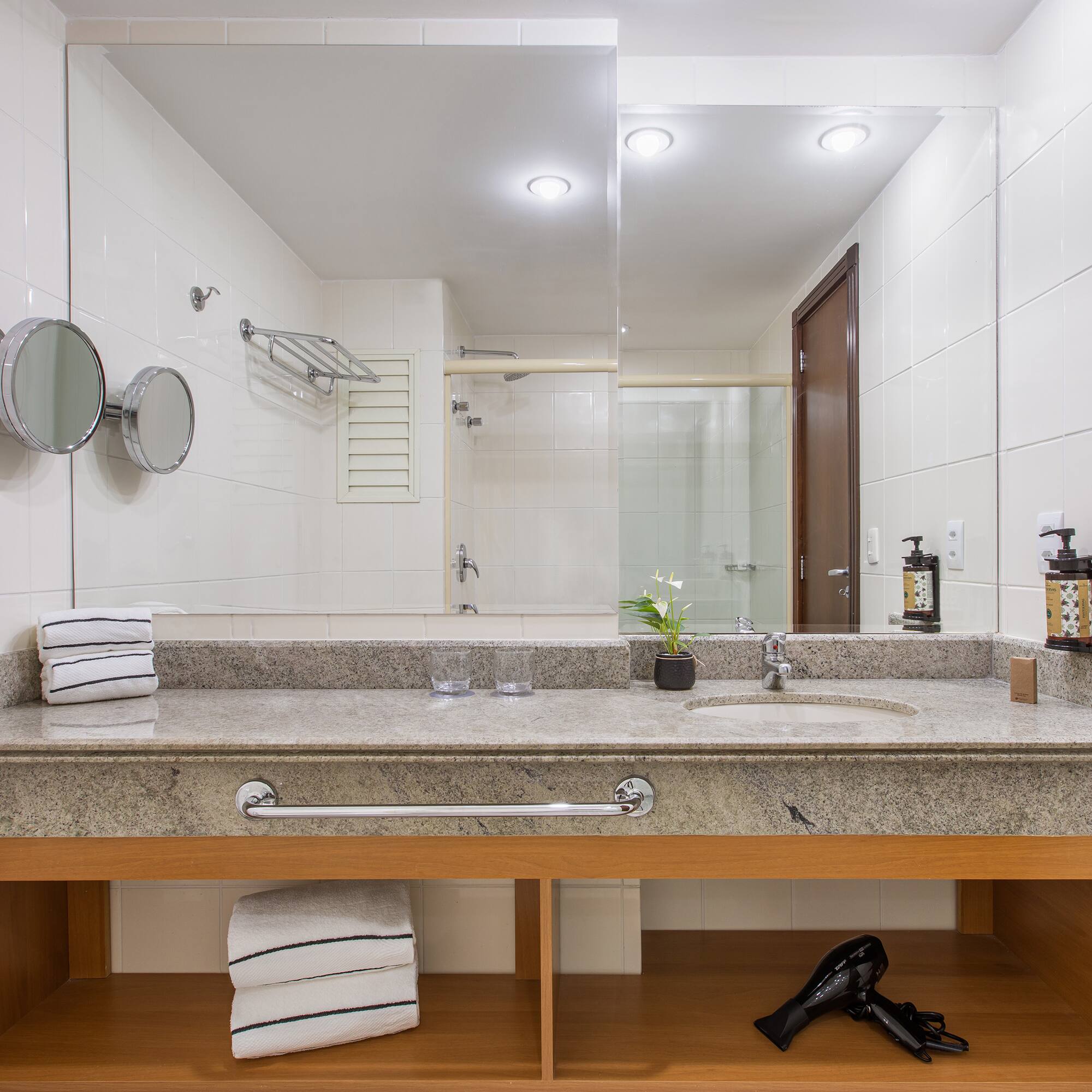 a bathroom with a sink and a blow dryer