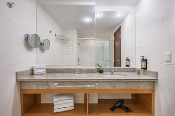 a bathroom with a sink and a blow dryer