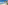 a beach with palm trees and blue water