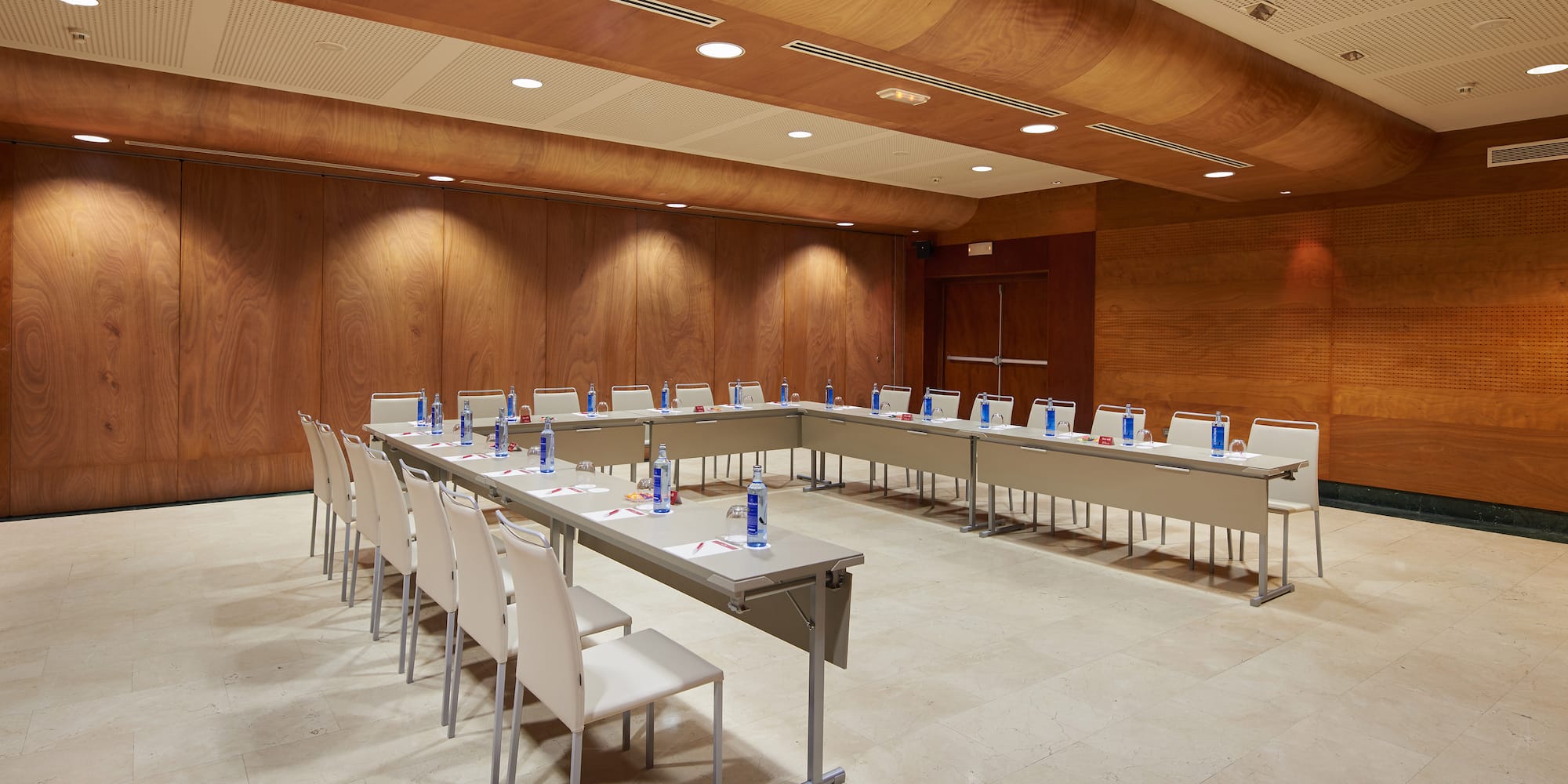 a room with a long table and chairs
