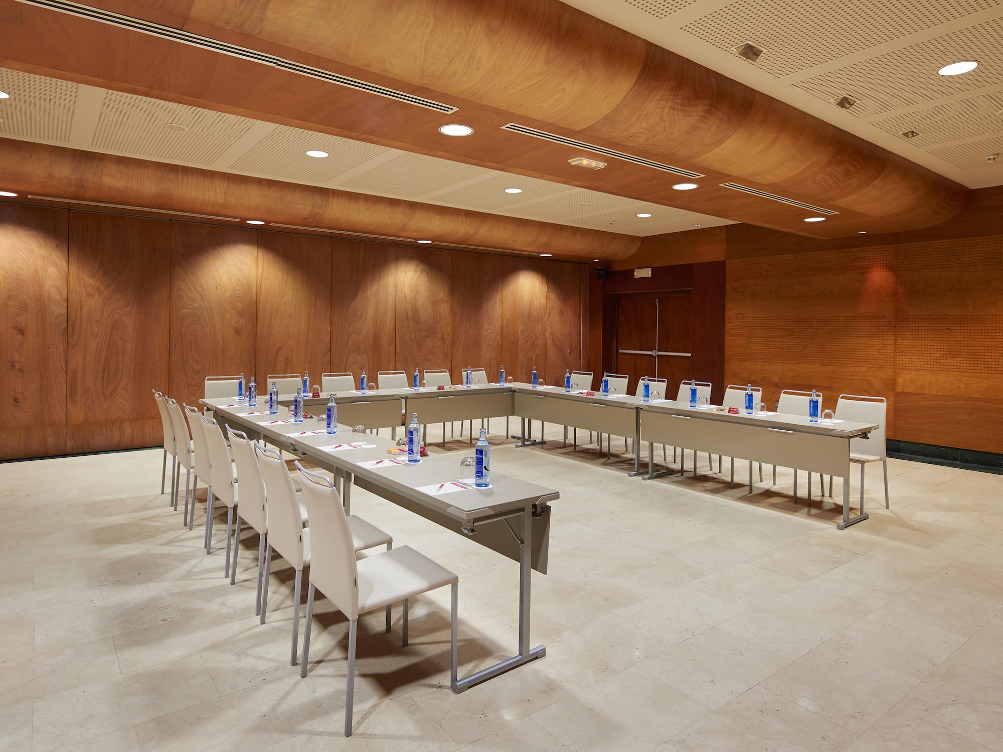 a room with a long table and chairs