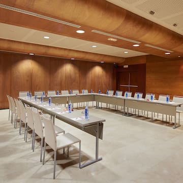 a room with a long table and chairs